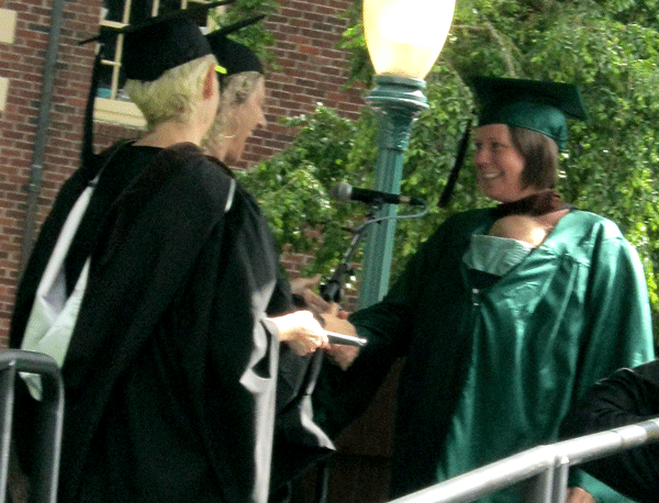 Accepting my degree with Juniper carried in my gown